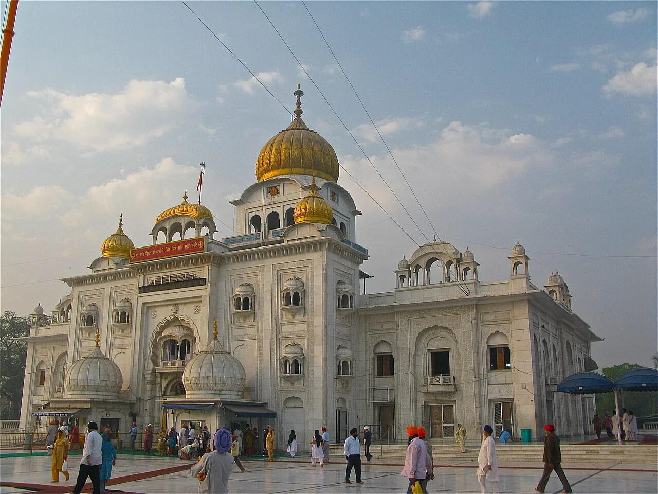 The golden dome and white facade of Gurudwara Bangla Sahib in New Delhi