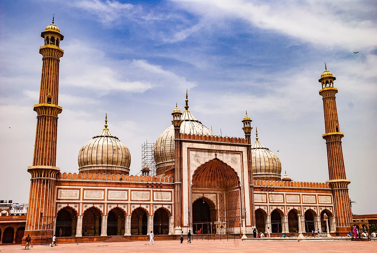 The sandstone entrance, marble domes and minarets of Jama Masjid in Delhi