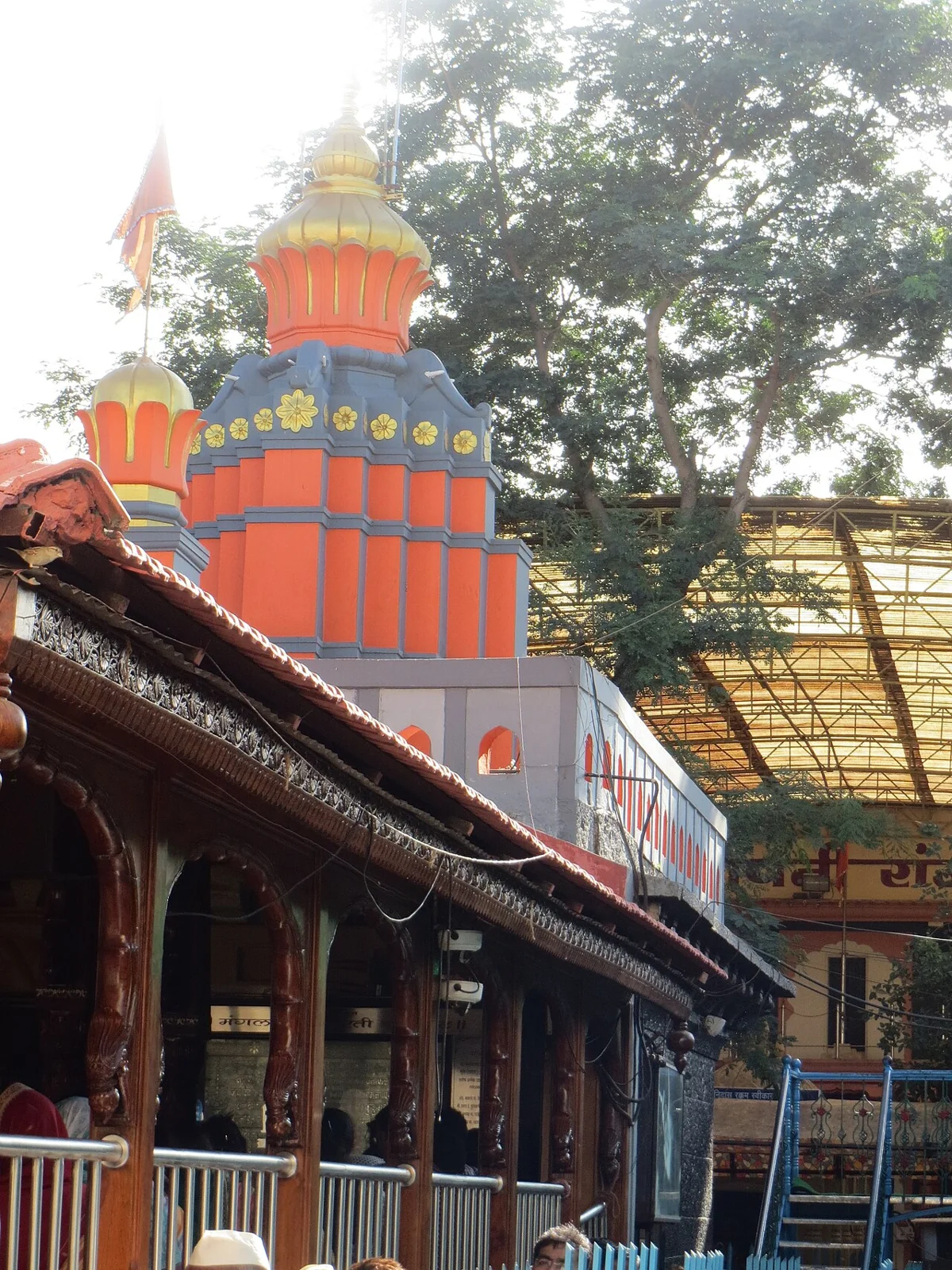 The orange temple tower above the courtyard of Mahaganpati Temple in Ranjangaon