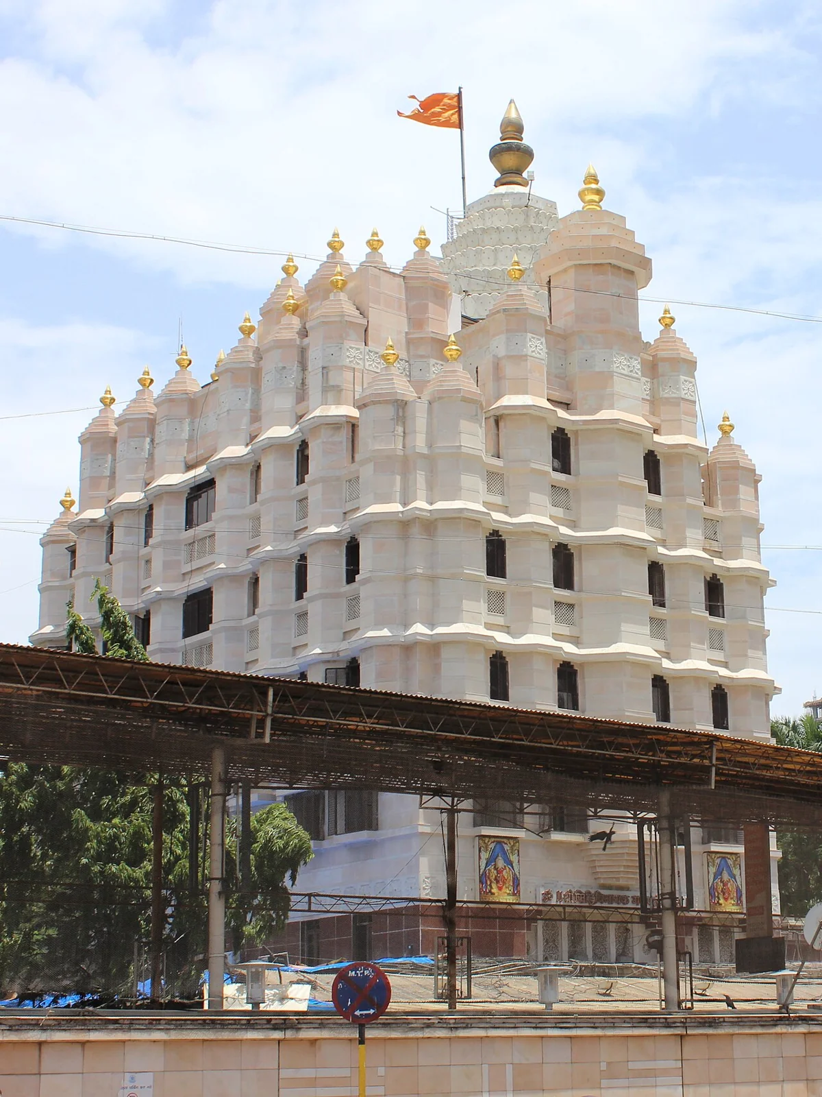 The pale facade and golden spires of Shree Siddhivinayak Temple in Mumbai
